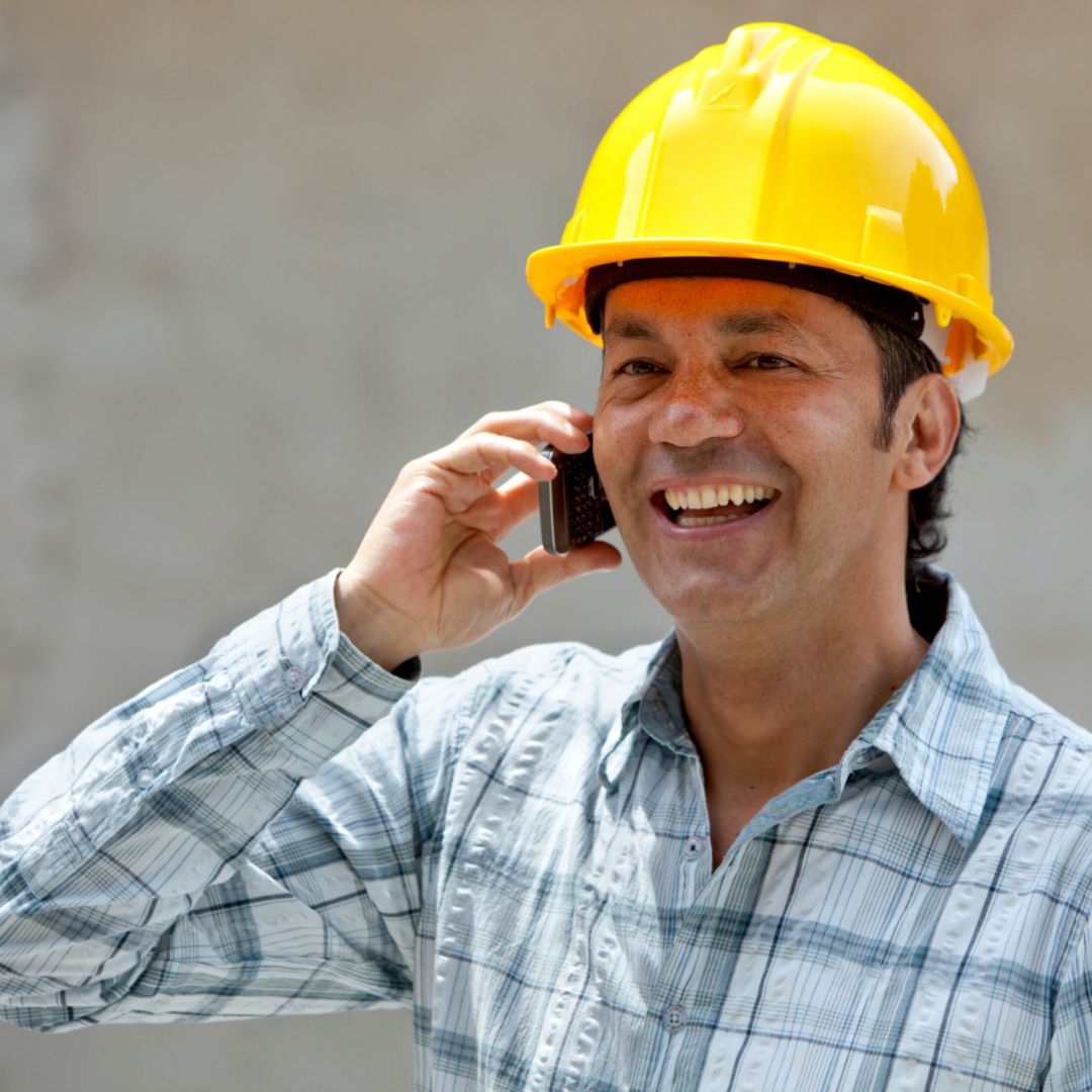 underground pipe contractor communicating with client on phone